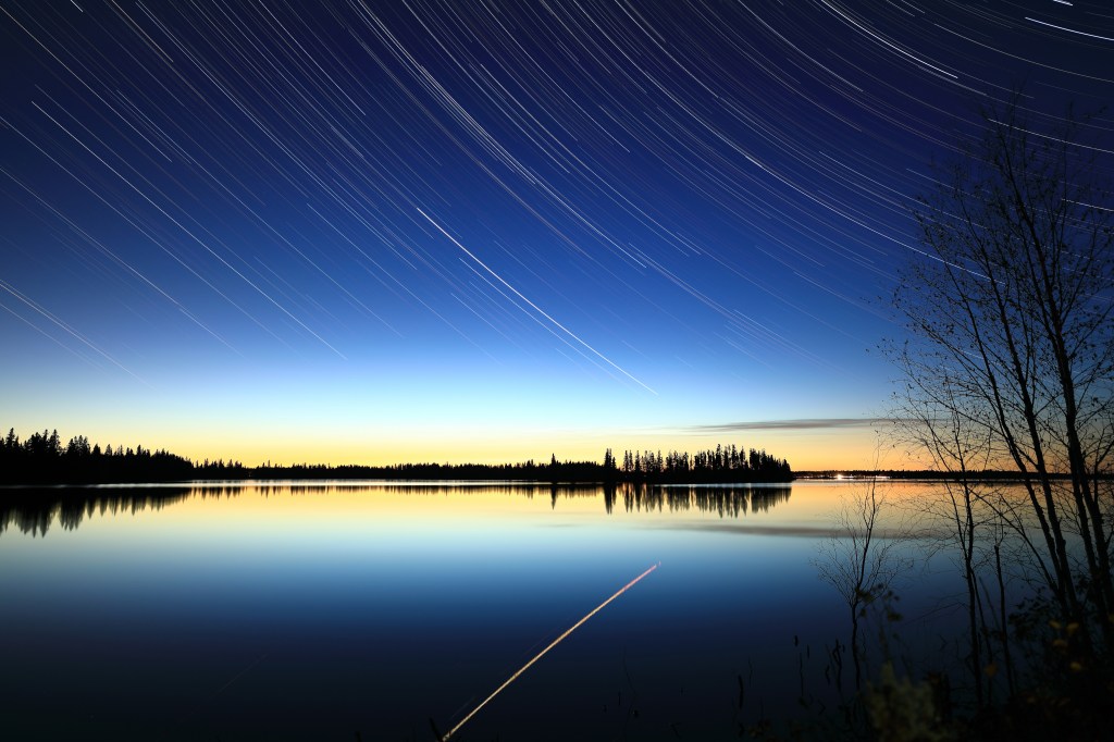 Star trail at Elk Island with reflection